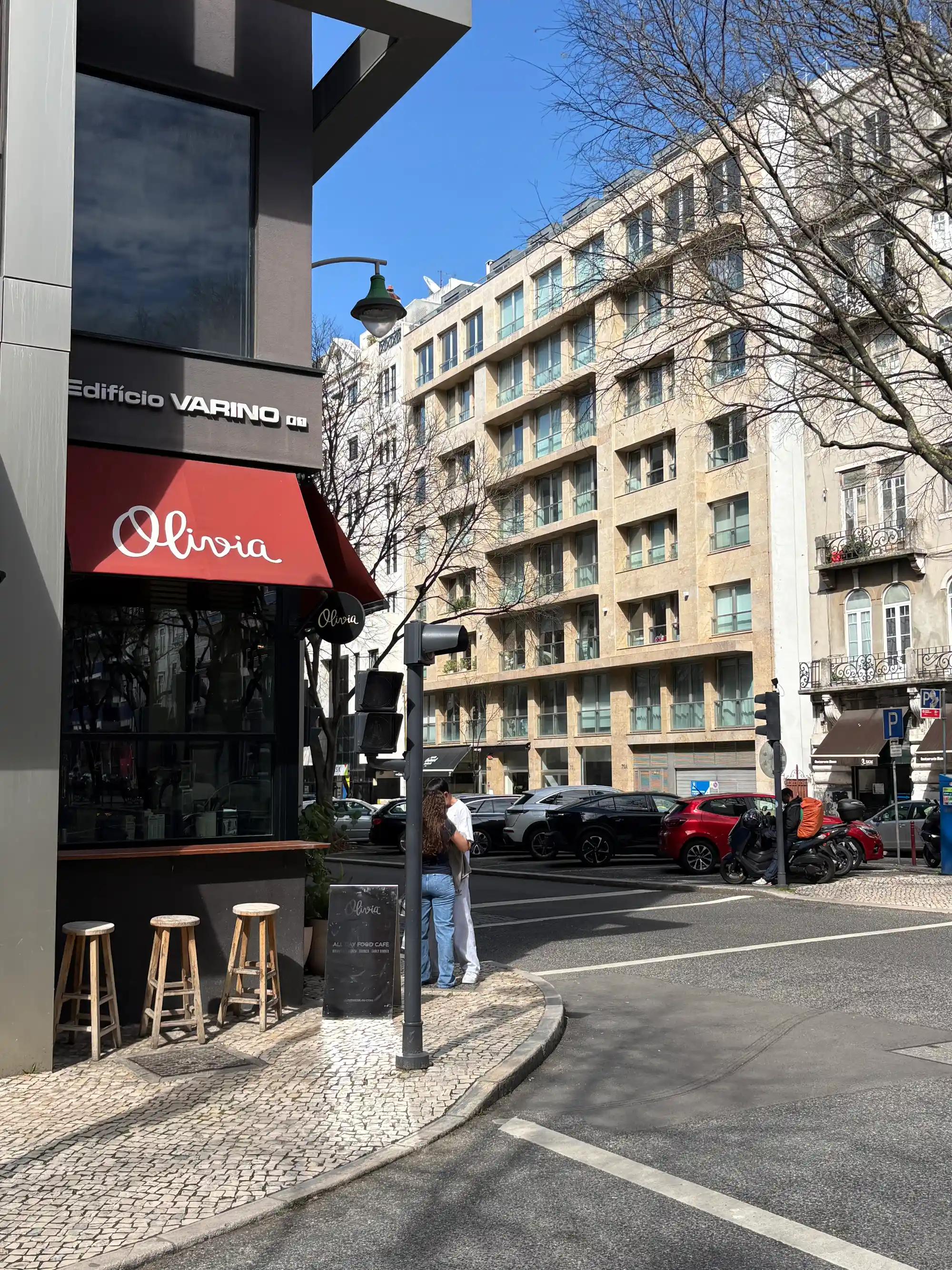 Street corner cafes and modern apartment buildings in Avenidas Novas, Lisbon, Portugal.