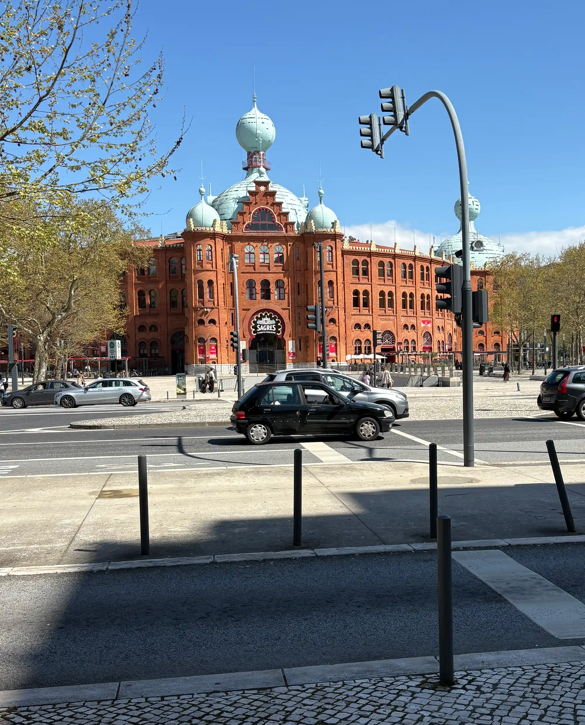 Campo Pequeno arena and traffic on a sunny day in Avenidas Novas, Lisbon, Portugal.