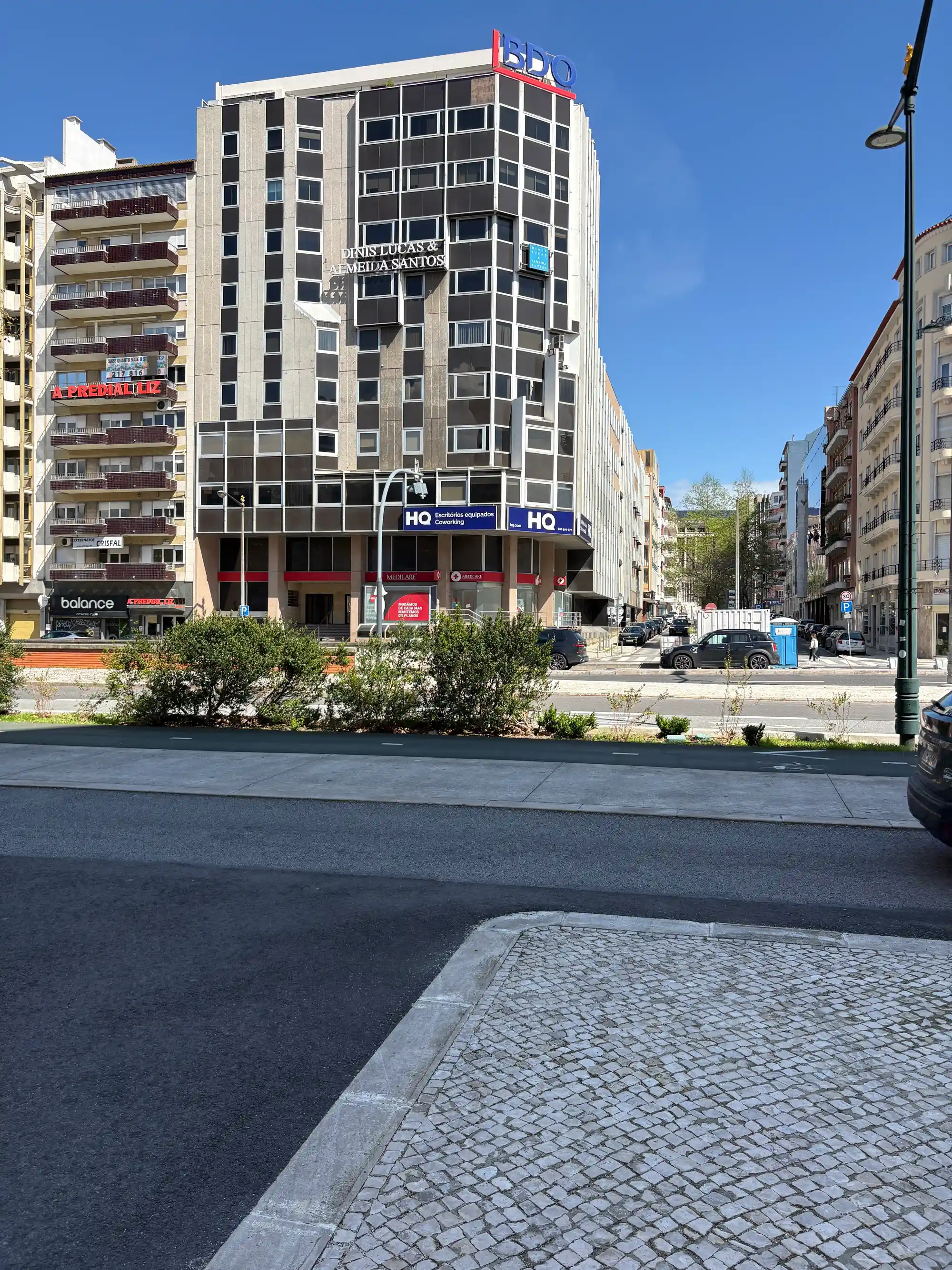 Modern office building and city street in Avenidas Novas, Lisbon, Portugal.
