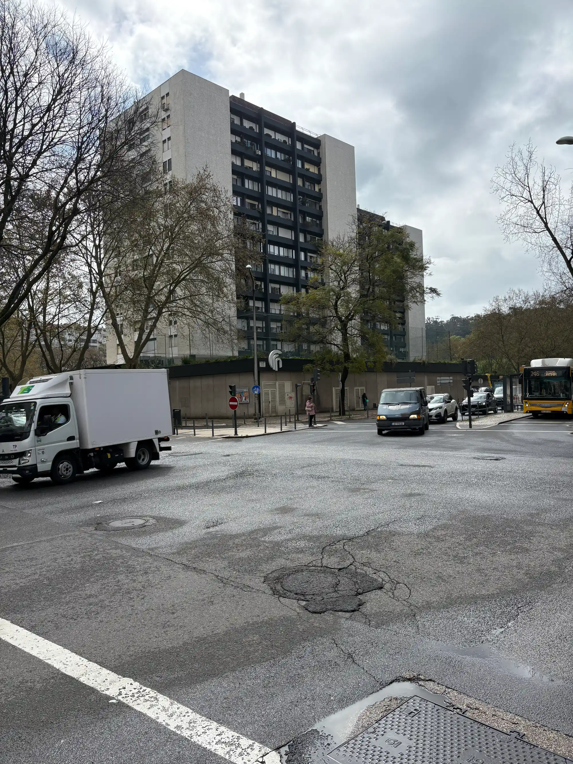 Benfica Lisbon residential area with apartment buildings, street intersection, and urban traffic