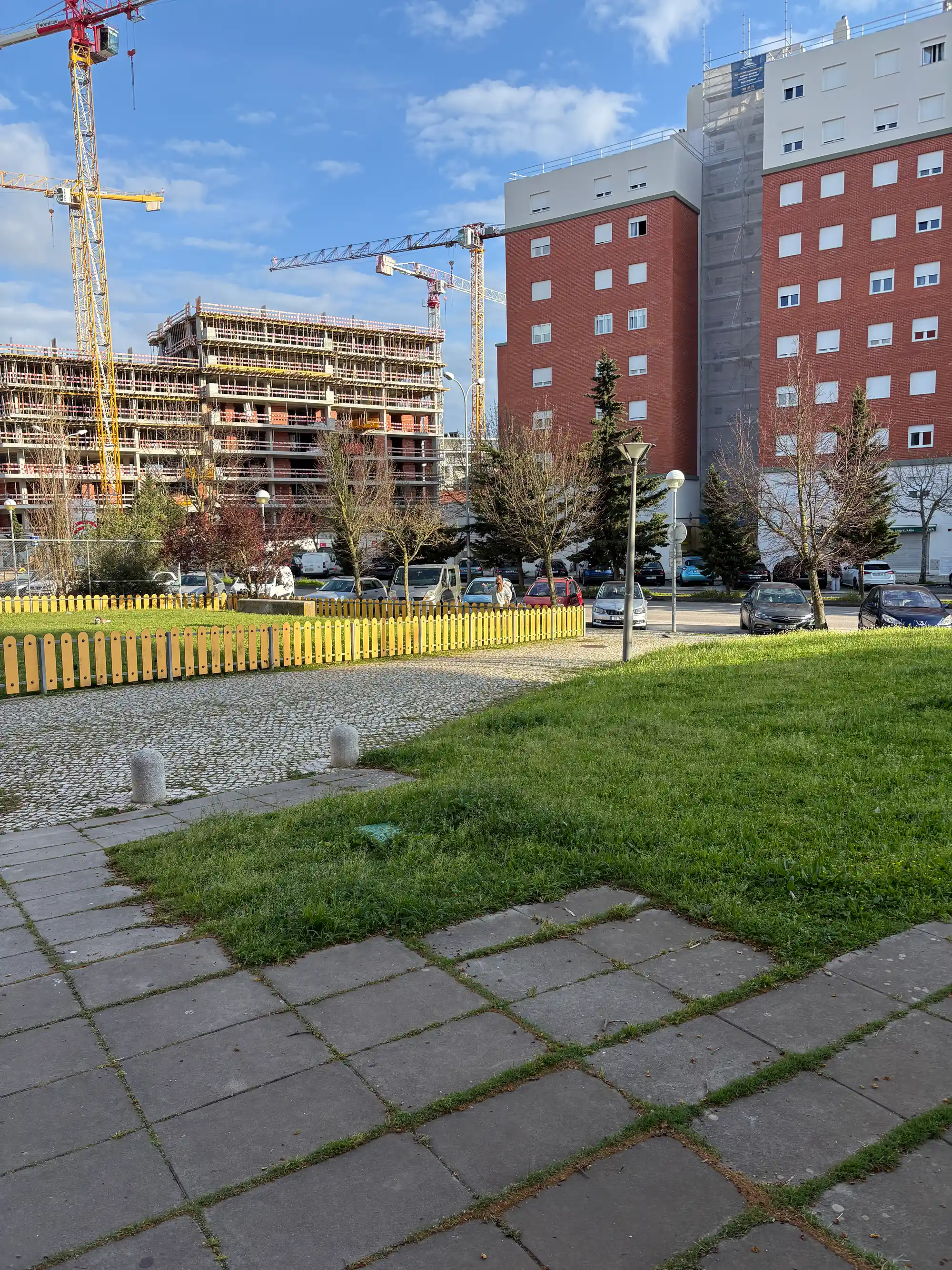 Lumiar Lisbon residential area with construction site, cranes, apartment buildings, and green public space