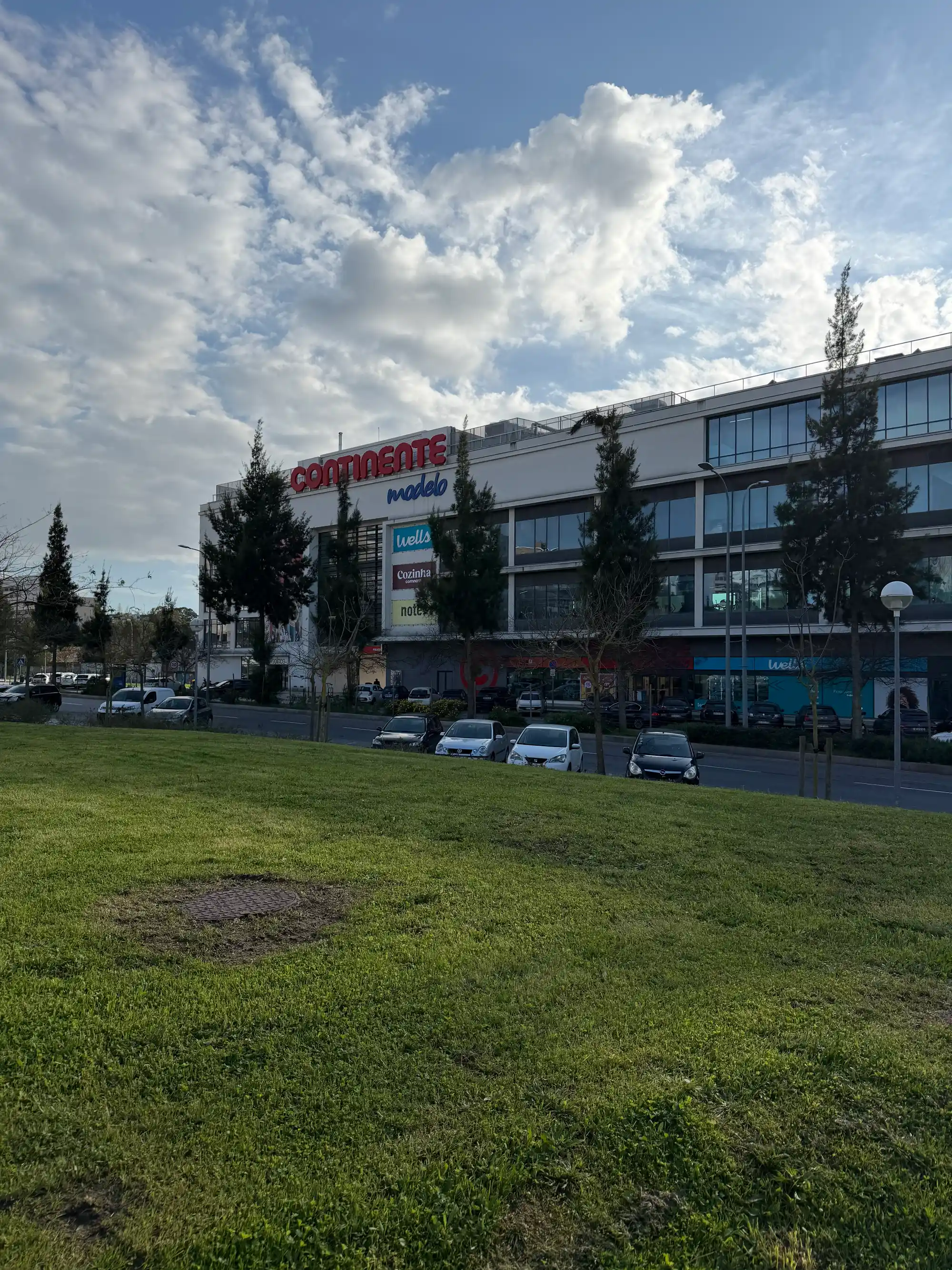 Lumiar Lisbon Continente Modelo supermarket with parking area, green space, and commercial district