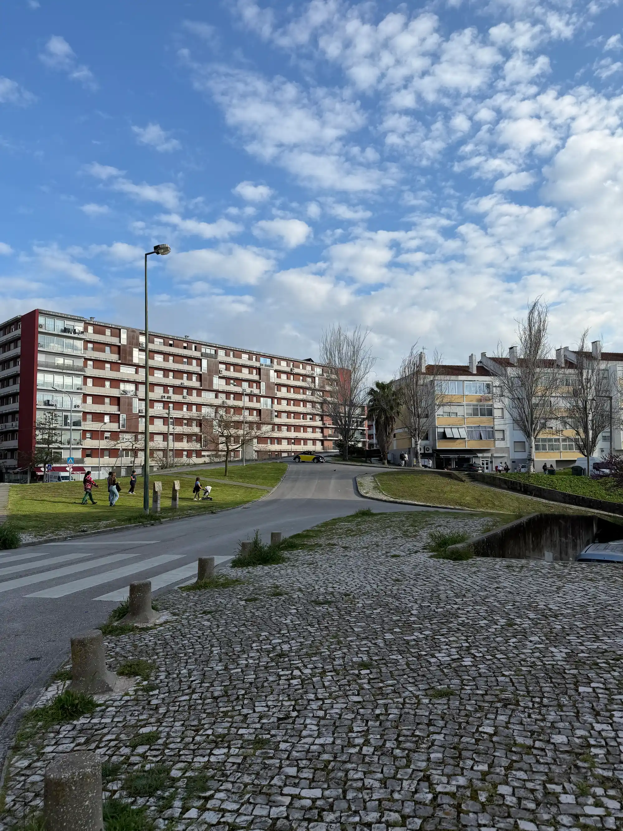 Lumiar Lisbon residential area with apartment buildings, green spaces, and pedestrians in urban neighborhood