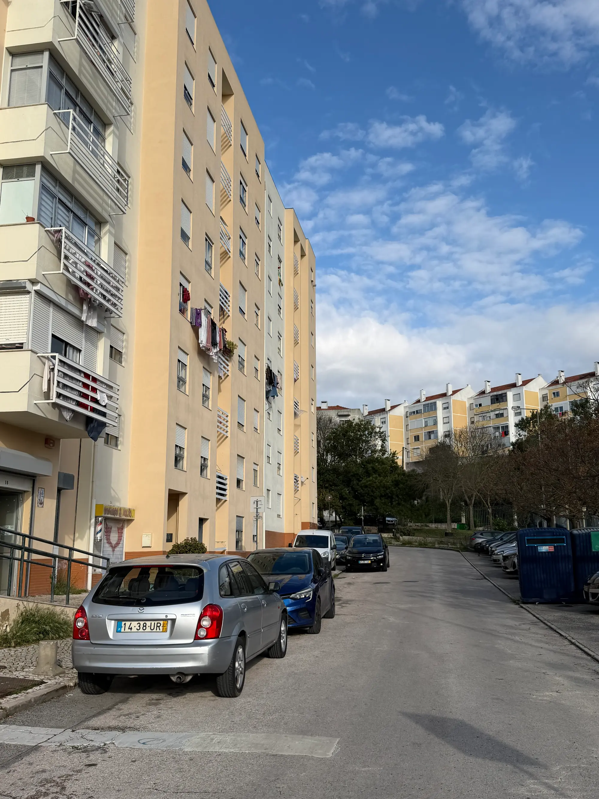 Lumiar Lisbon residential street with apartment buildings, parked cars, and urban neighborhood setting