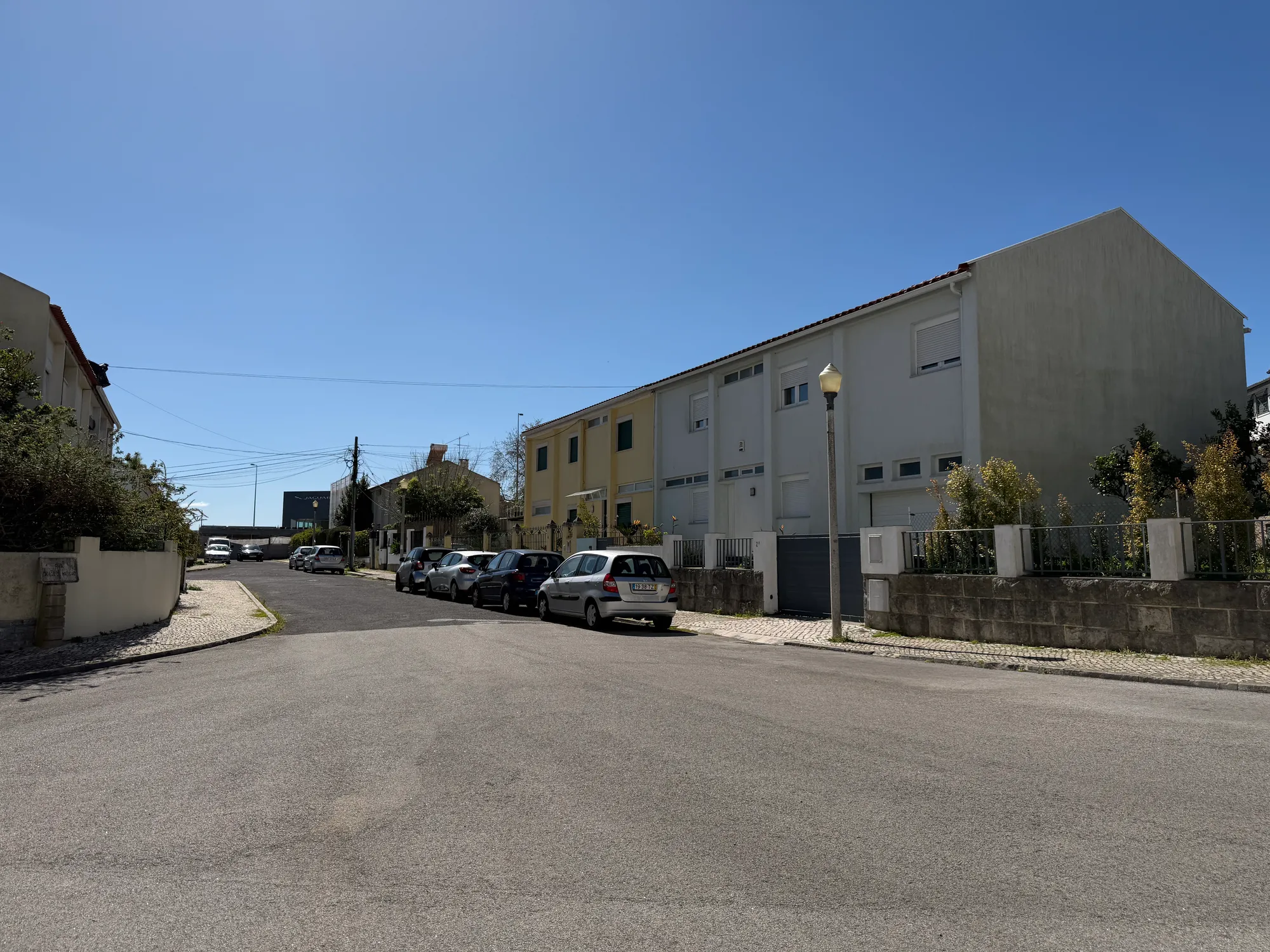 Olivais Lisbon residential street with houses, parked cars, and quiet suburban neighborhood setting