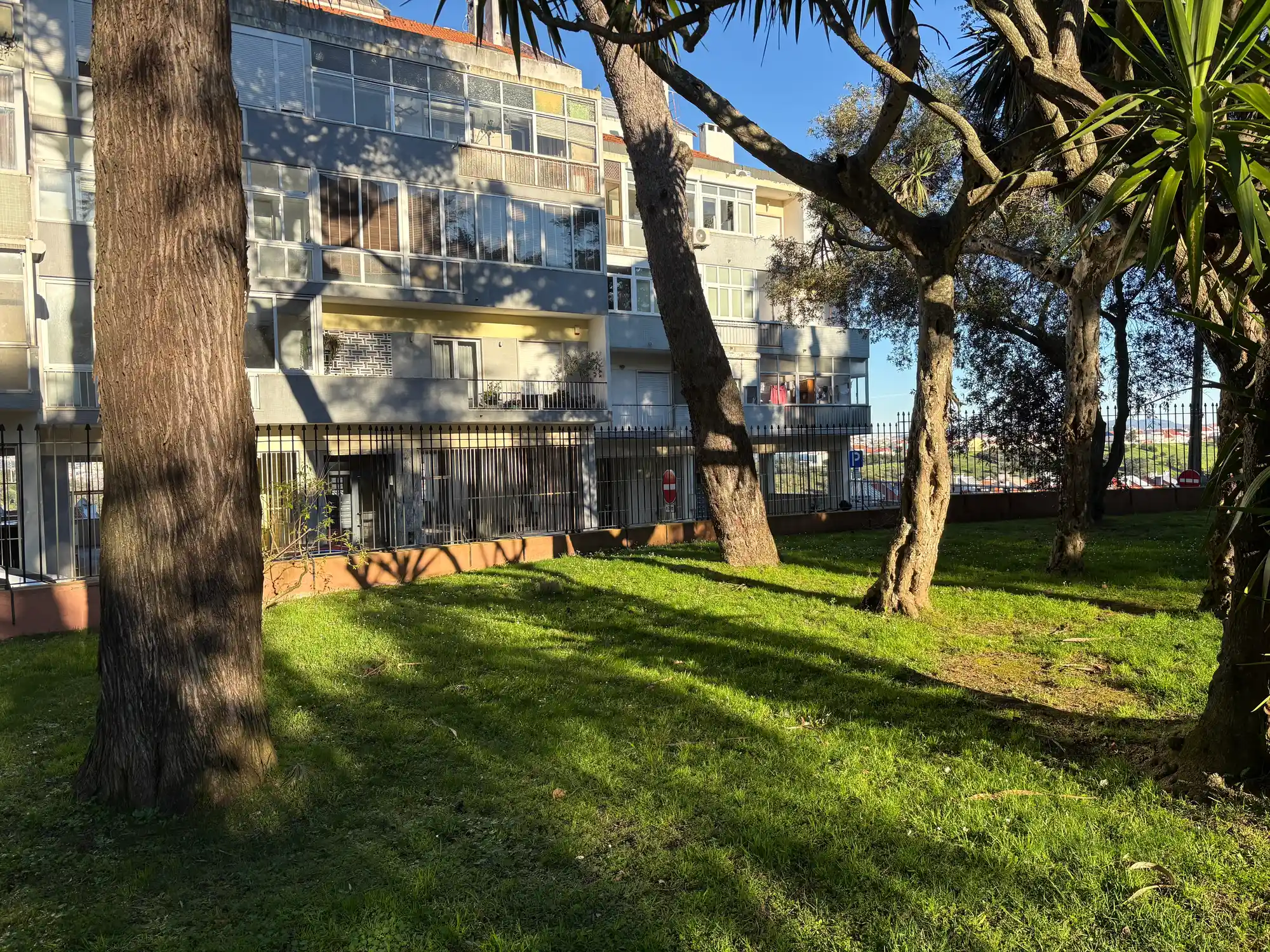 Santa Clara Lisbon residential area with apartment building, trees, and green courtyard space
