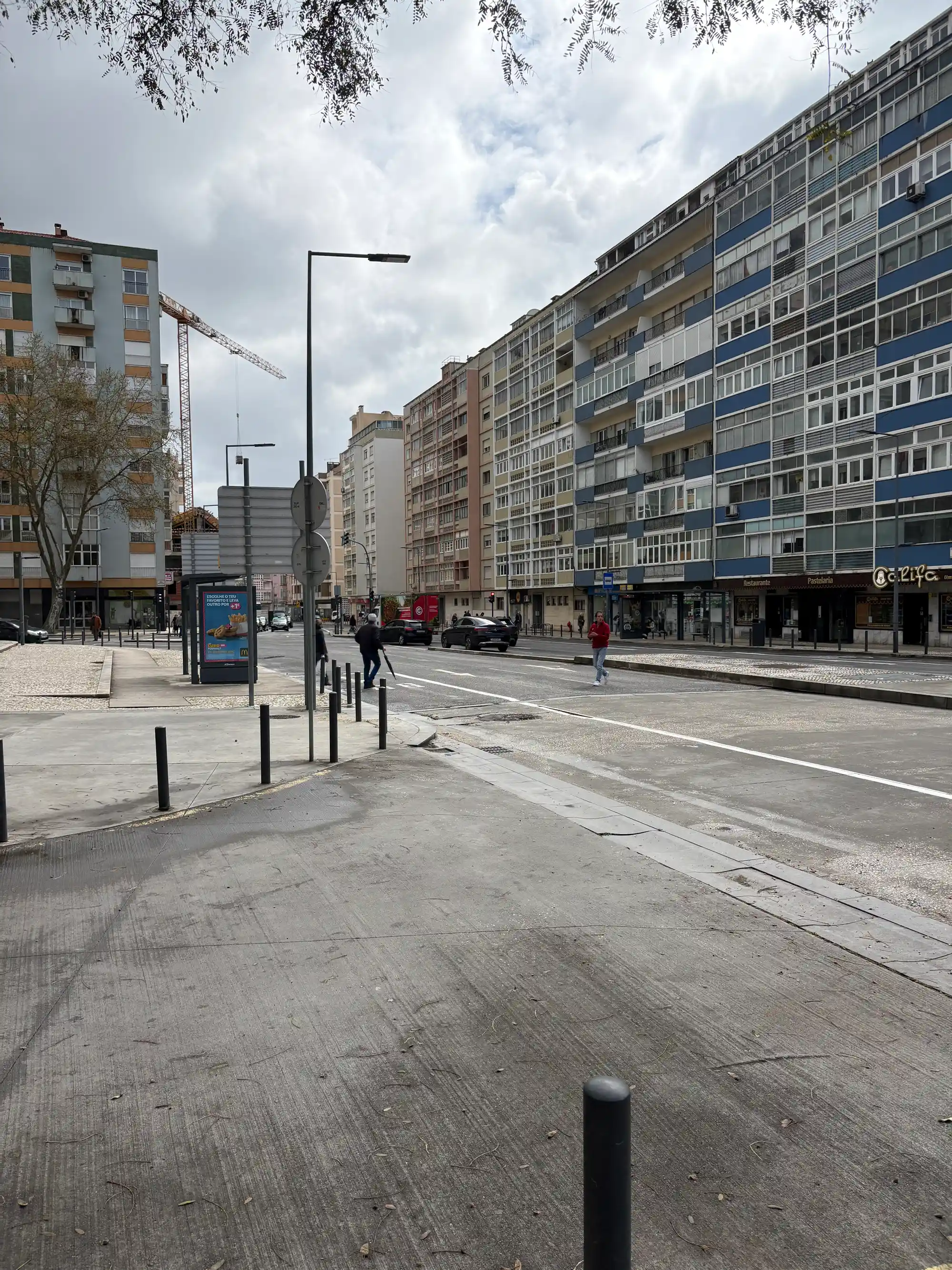 São Domingos de Benfica is a Lisbon urban street with apartment buildings, pedestrian walkways, and local shops.